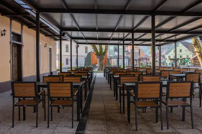 a row of tables and chairs in a building at Gostišče Pod Kostanji in Dobrna