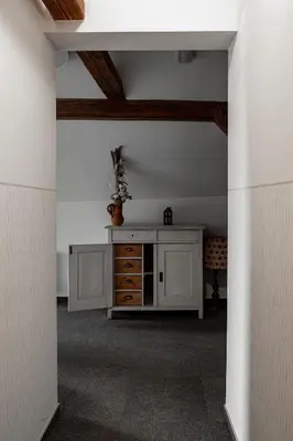 an attic room with a dresser in a room at Gostišče Pod Kostanji in Dobrna