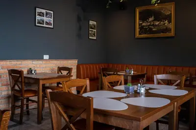a dining room with wooden tables and chairs at Gostišče Pod Kostanji in Dobrna