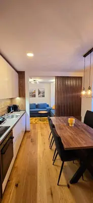 a kitchen and dining room with a wooden table at Poku bajka in Kranjska Gora