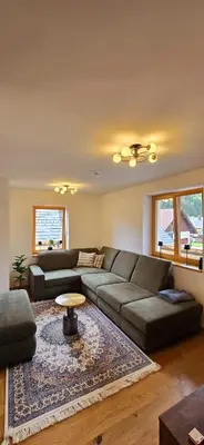 a living room with a couch and a table at Poku bajka in Kranjska Gora