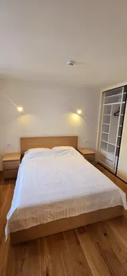 a bedroom with a large bed and a window at Poku bajka in Kranjska Gora