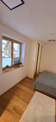 a bedroom with a bed and a window at Poku bajka in Kranjska Gora