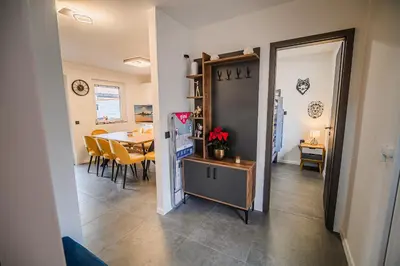 a dining room and living room with a table and chairs at Holiday Home Villa Rio in Terme Čatež in Čatež ob Savi