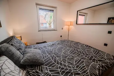 a bedroom with a large bed and a mirror at Holiday Home Villa Rio in Terme Čatež in Čatež ob Savi