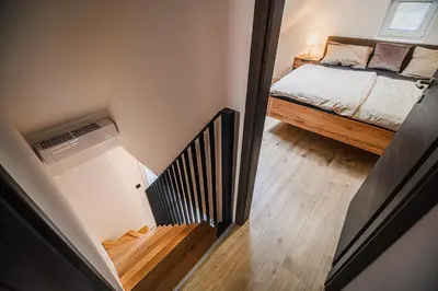 a small room with a bed and a stairway at Holiday Home Villa Rio in Terme Čatež in Čatež ob Savi