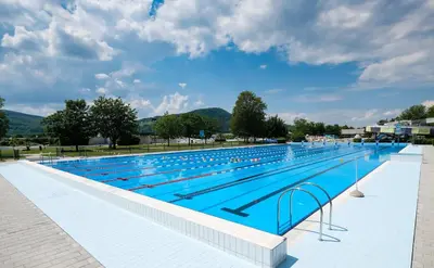 a large swimming pool with blue water at Holiday Home Villa Rio in Terme Čatež in Čatež ob Savi