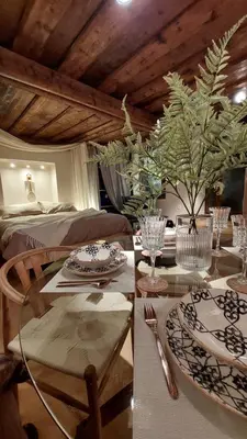 a dining room with a table and a bed at Bartolomeo Apartment in Ljubljana
