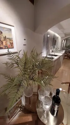 a table with wine glasses and a plant on it at Bartolomeo Apartment in Ljubljana