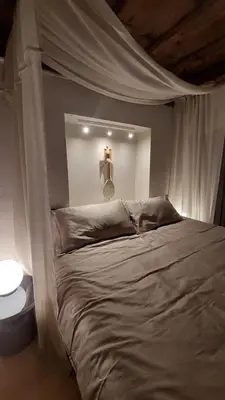 a bedroom with a bed with a white canopy at Bartolomeo Apartment in Ljubljana