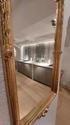 a mirror reflection of a kitchen with a counter at Bartolomeo Apartment in Ljubljana