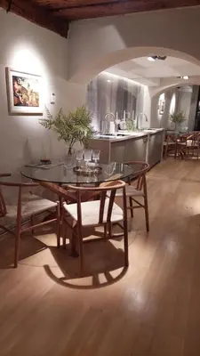 a dining room with a table and a kitchen at Bartolomeo Apartment in Ljubljana
