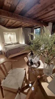 a bedroom with a bed and a table with a potted plant at Bartolomeo Apartment in Ljubljana