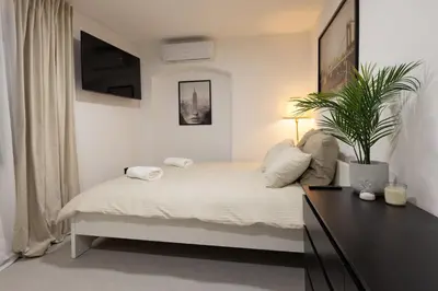 a bedroom with a bed with a plant on it at Apartments Napoleon in Ljubljana