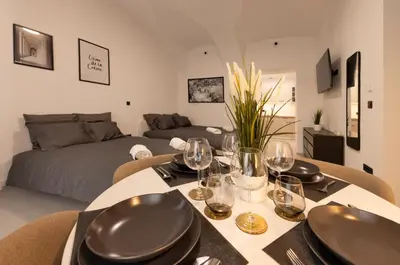 a dining room with a table with wine glasses at Apartments Napoleon in Ljubljana