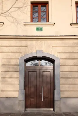 a building with a wooden door in front at Apartments Napoleon in Ljubljana