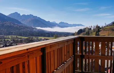 a wooden balcony with a view of a valley at Alpine Retreat house Šurc in Rateče