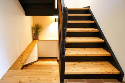 a staircase in a house with wooden floors at Alpine Retreat house Šurc in Rateče