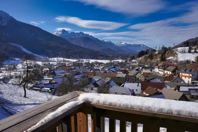 a view of a town with snow covered roofs at Alpine Retreat house Šurc in Rateče