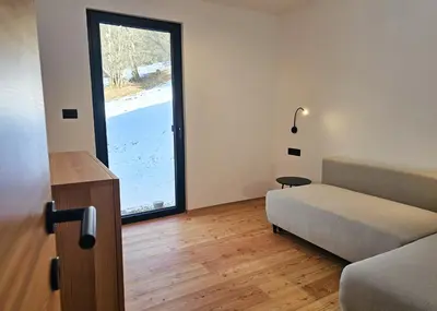 a room with a bed and a large window at Alpine Retreat house Šurc in Rateče