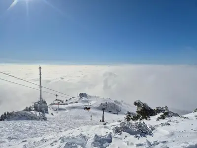 a snow covered ski slope with a ski lift at New cosy apartment in nature - Krvavec in Cerklje na Gorenjskem