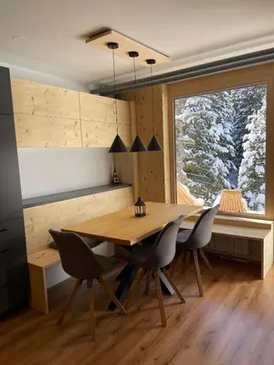 a dining room with a wooden table and chairs at New cosy apartment in nature - Krvavec in Cerklje na Gorenjskem