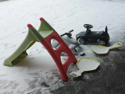 a pair of scissors and a toy car in the snow at Apartma Escales -naselje Nune-Rogla in Zreče