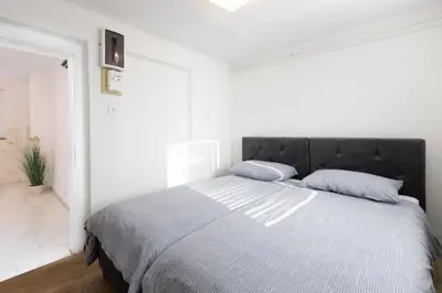 a bedroom with a large bed in a white room at Apartment Pohorje Sun - Entire house in Maribor