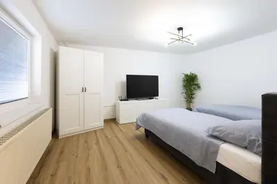 a bedroom with a bed and a flat screen tv at Apartment Pohorje Sun - Entire house in Maribor