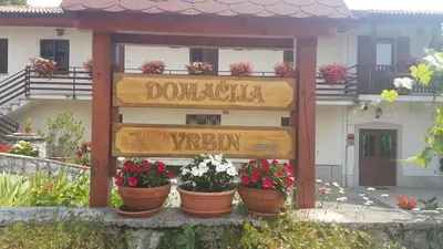 a sign for a garden with flowers in pots at Homestead Vrbin in Divača