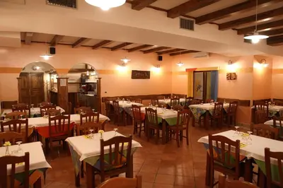 a restaurant with tables and chairs with white tablecloths at Homestead Vrbin in Divača