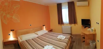 a bedroom with a bed with towels on it at Homestead Vrbin in Divača