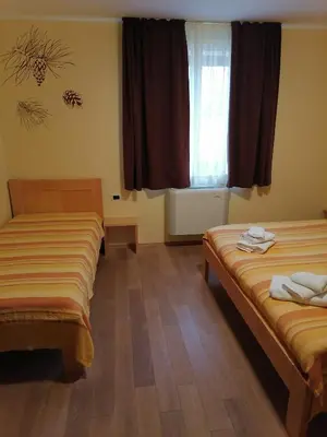 a hotel room with two beds and a window at Homestead Vrbin in Divača