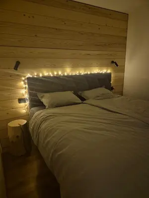 a bedroom with a bed with lights on it at New cosy apartment, smučišče Krvavec in Cerklje na Gorenjskem