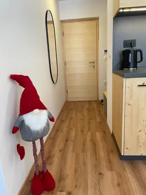 a room with a gnome hanging on the wall at New cosy apartment, smučišče Krvavec in Cerklje na Gorenjskem
