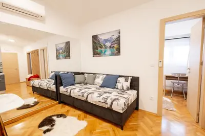 a living room with a couch in a room at Hozi House -4 cozy apartment's in Ljubljana