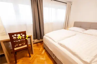 a bedroom with a bed and a desk and a chair at Hozi House -4 cozy apartment's in Ljubljana