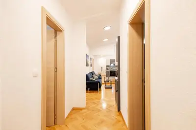 a hallway with a door open to a living room at Hozi House -4 cozy apartment's in Ljubljana
