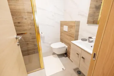 a bathroom with a toilet and a sink at Hozi House -4 cozy apartment's in Ljubljana