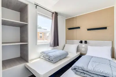a small bedroom with a bed and a window at Eurocamp Mobile Homes Terme Catez in Brežice