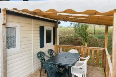 a patio with a table and chairs on a deck at Eurocamp Mobile Homes Terme Catez in Brežice