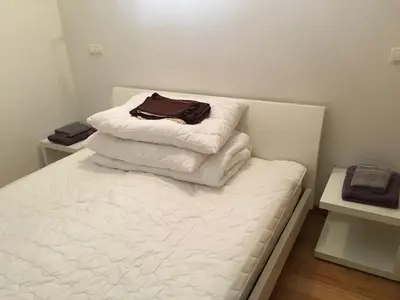 two stacks of towels sitting on top of a bed at Apartment Happy Place in Bohinj