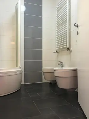 a bathroom with a sink and a toilet and a window at Apartment Happy Place in Bohinj