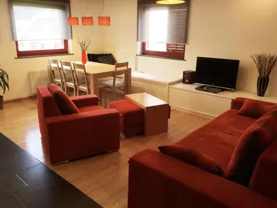a living room with two couches and a television at Apartment Happy Place in Bohinj