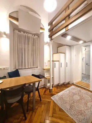 a living room with a table and a dining room at Courtyard Studio City Center in Ljubljana