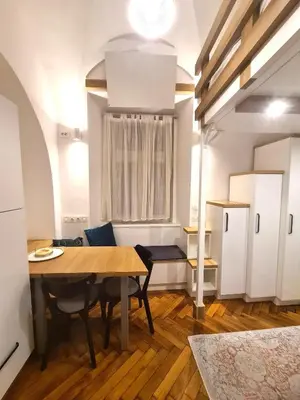 a kitchen and dining room with a table and chairs at Courtyard Studio City Center in Ljubljana