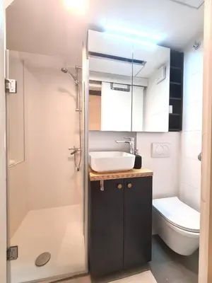 a small bathroom with a sink and a toilet at Courtyard Studio City Center in Ljubljana