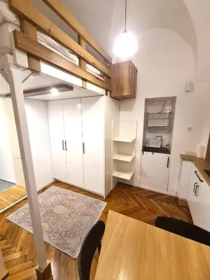 a room with a loft bed and a table at Courtyard Studio City Center in Ljubljana