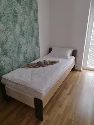 a bed in a bedroom with a blanket on it at Lazy Haven in Moravske Toplice