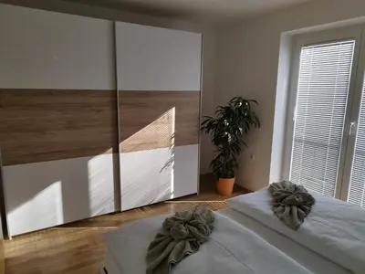a bedroom with two beds and a large mirror at Lazy Haven in Moravske Toplice
